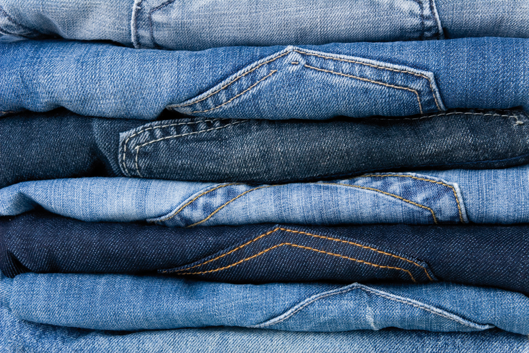 Stack of different denim jeans