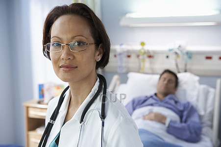 Female doctor with patient in background