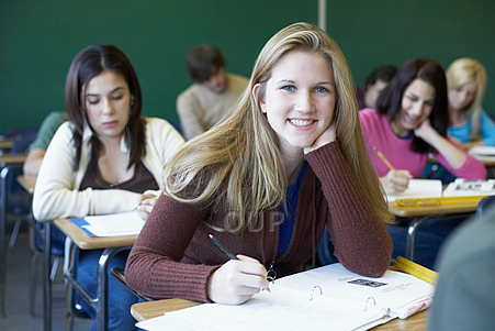 Young woman working and smiling in classroom