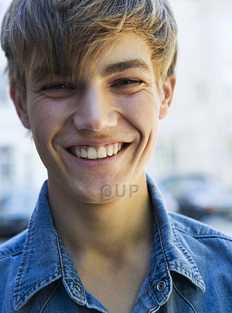 Male teenager smiling confidently