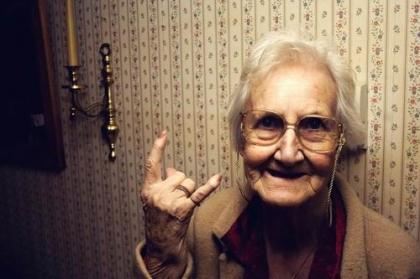 Elderly lady making a devil gesture with her hand
