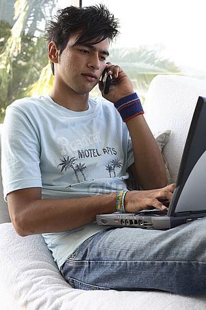 Teenage boy on laptop and phone