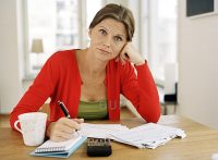 Woman with notepad looking confused