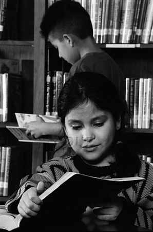 Young girl reading in a library