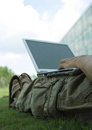 Laptop on legs on the grass
