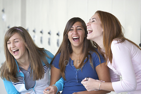 Three school girls laughing