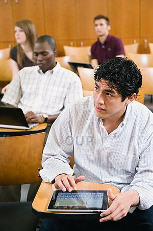 Students in lecture with digital gadgets