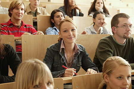Blonde woman smiling in college class