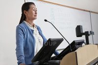 Female teacher in lecture theatre.