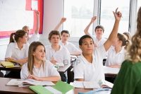 Secondary school students in a classroom answering questions