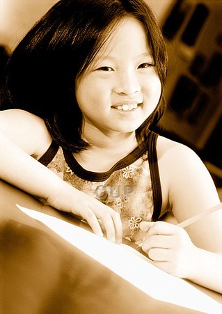 Girl smiling and writing