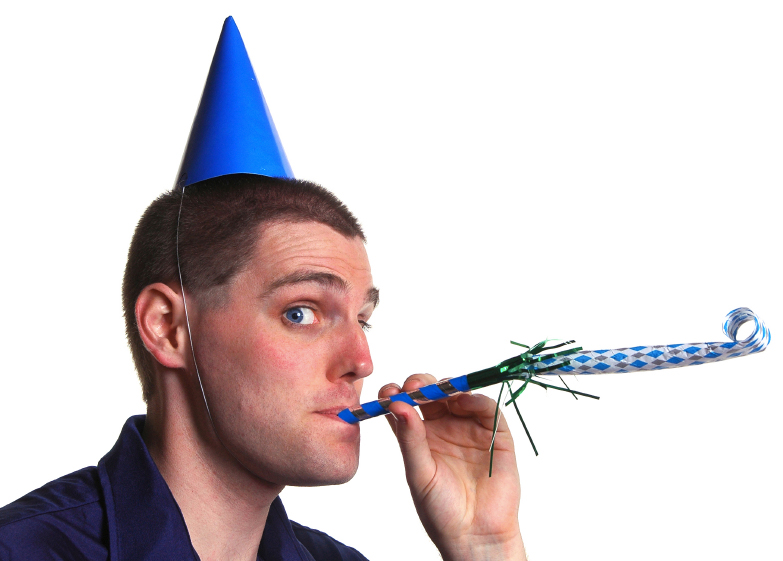 Man with a party hat and whistle