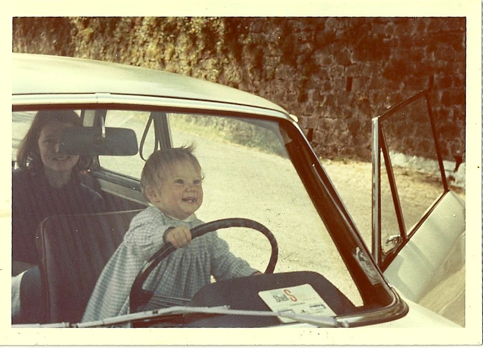 Kenna Bourke as a toddler 'driving' a car