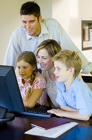 Family gathered round computer