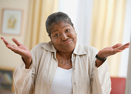 Middle aged African woman shrugging her shoulders