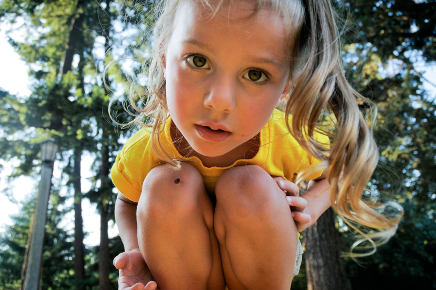 Curious child crouching in forest