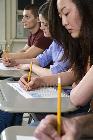 Students Sitting at Desks and Writing